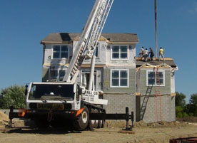 Crane set on multi-level modular construction house project.